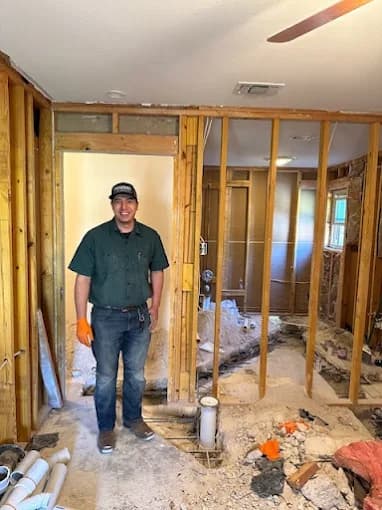 Proverbs Plumbing technician standing in a gutted bathroom during a remodel plumbing rough-in