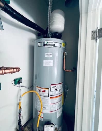 AO Smith gas water heater tagged by Proverbs Plumbing with a thermal expansion tank overhead