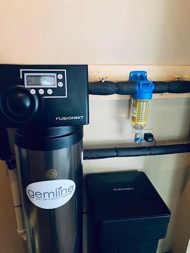Gemline water conditioner beside a FusionXT whole-house sediment filter and brine tank